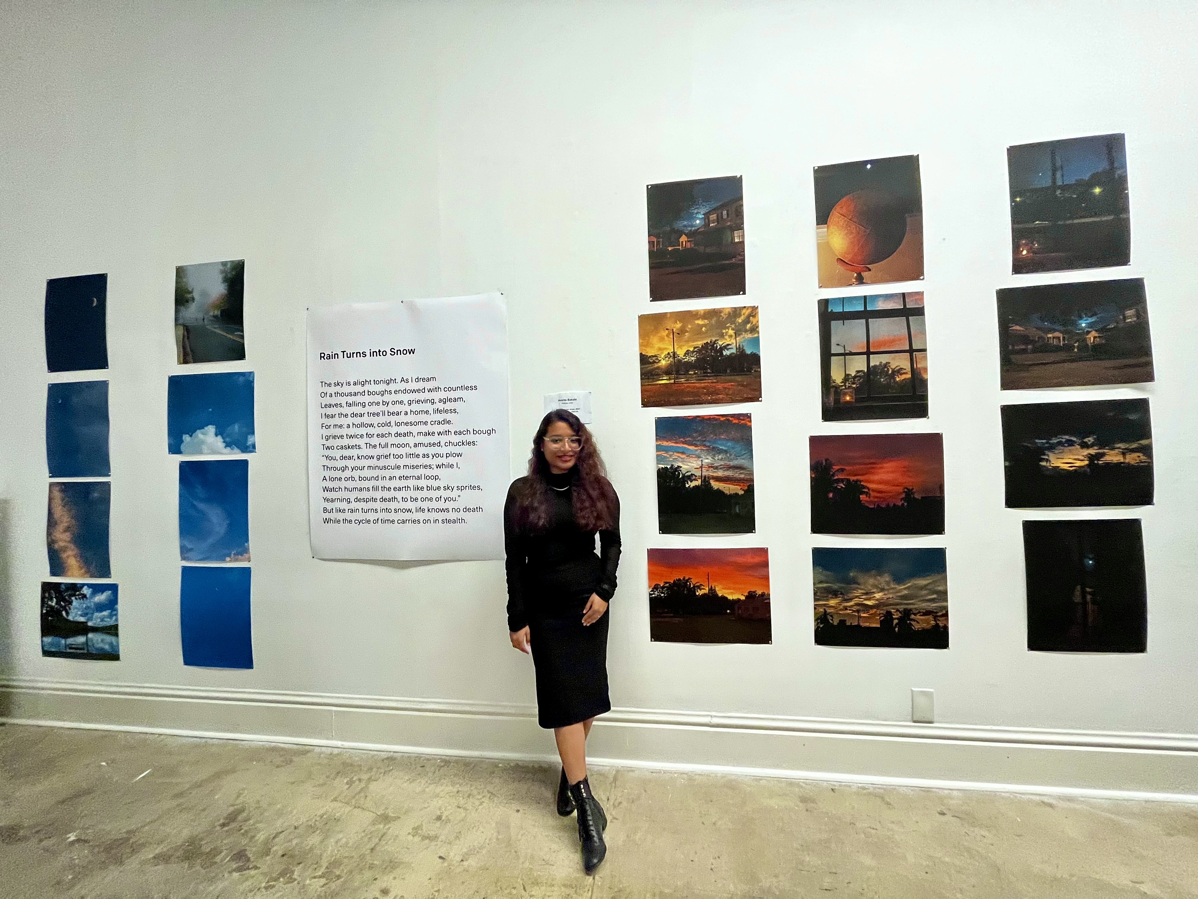 Amrita Bakshi beside her exhibited poem Rain Turns into Snow