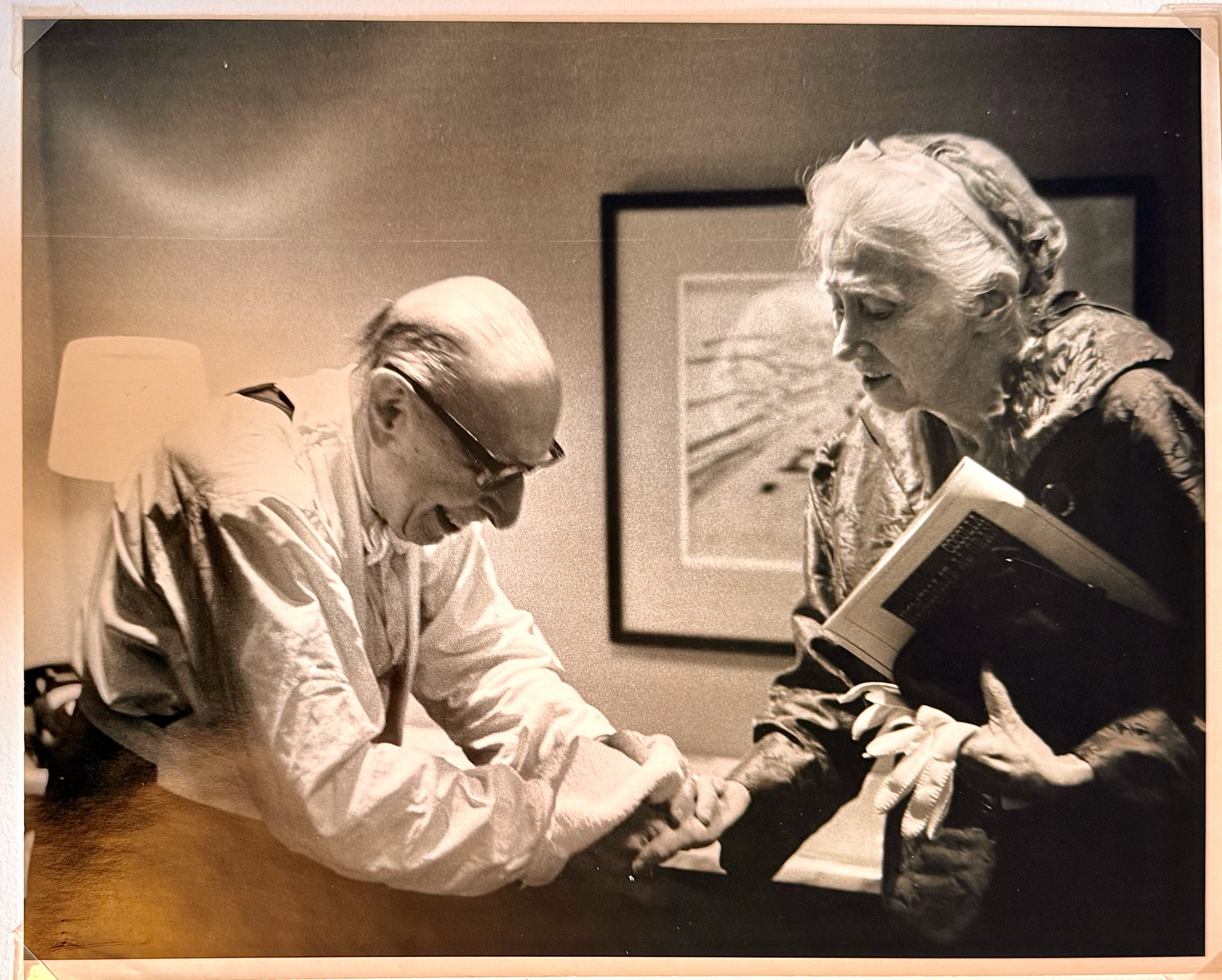 Igor Stravinsky bowing over Marianne Moore's hands